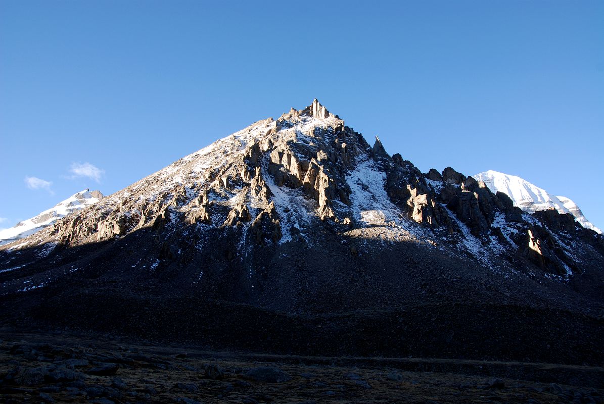 44 Early Morning Sun Highlights The Jagged Ridges Of Avalokiteshvara Chenrezig Guardian Peak With Mount Kailash North Face From Just Before Shiva Tsal On Mount Kailash Outer Kora The early morning sun highlights the jagged ridges of the guardian peak Avalokiteshvara (Tib. Chenrezig) with the north face of Mount Kailash to the right.